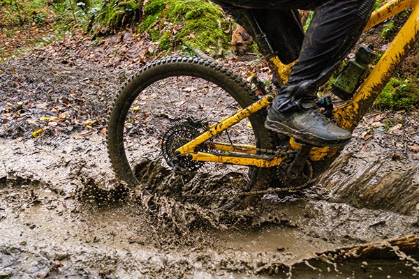 Specialized bike with contintental tyres riding through muddy water